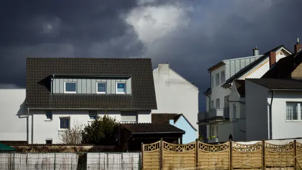 Suburban houses under a dramatic cloudy sky