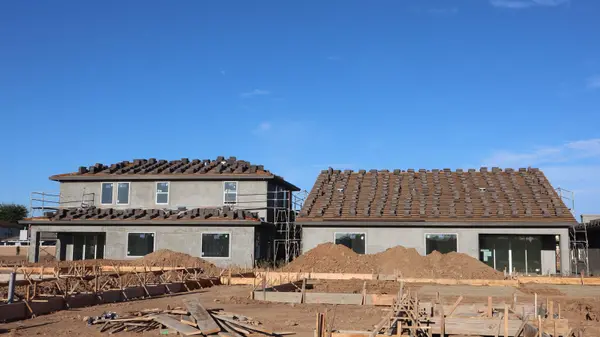 Newly constructed houses under a clear blue sky