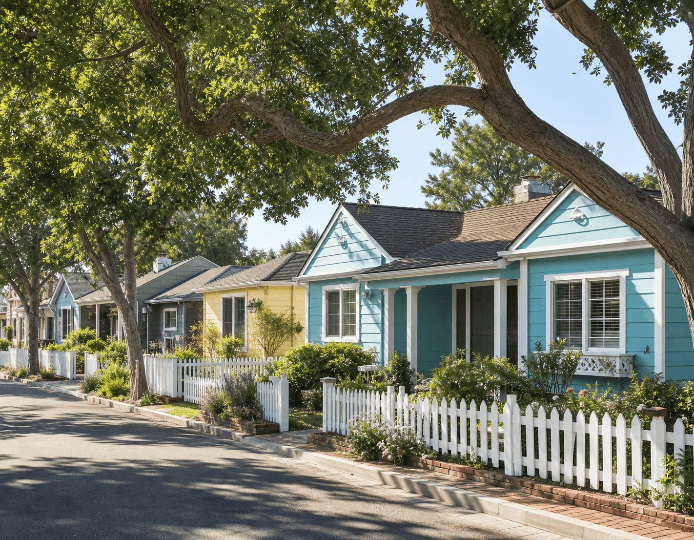 Quiet Old Town Seal Beach street of low coastal cottages with white picket fencing and mature trees