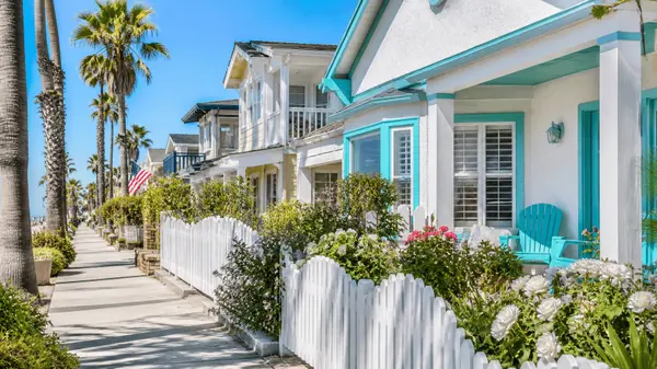 Pastel beach cottages along a palm-lined coastal street in Long Beach