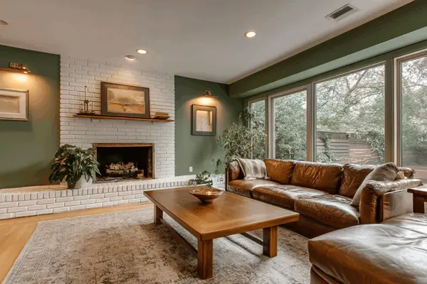 green living room with white brick fireplace
