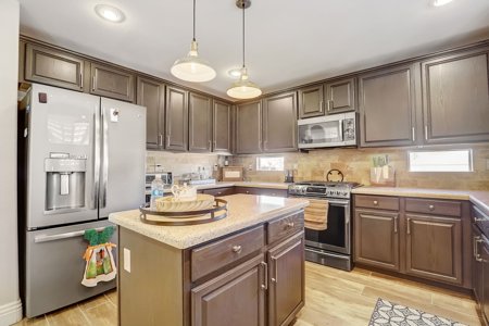 Updated kitchen with island and stainless appliances in a Henderson, NV home