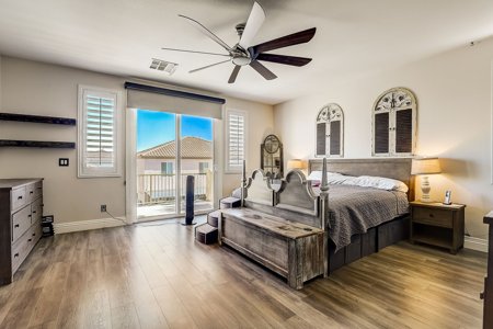 Spacious primary bedroom with balcony access in a Henderson, NV home