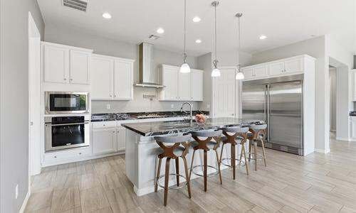 Bright white kitchen with a granite island in a Henderson Nevada home