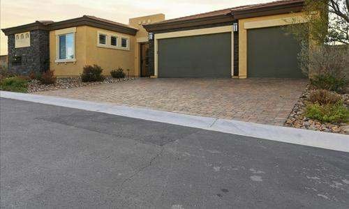 Henderson Nevada home with a three car garage and paver driveway at sunset