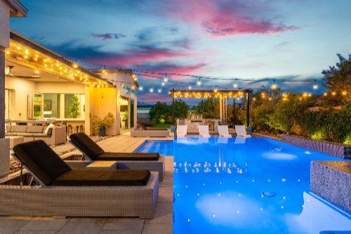 Resort-style pool and outdoor lounge at twilight in a Henderson NV home
