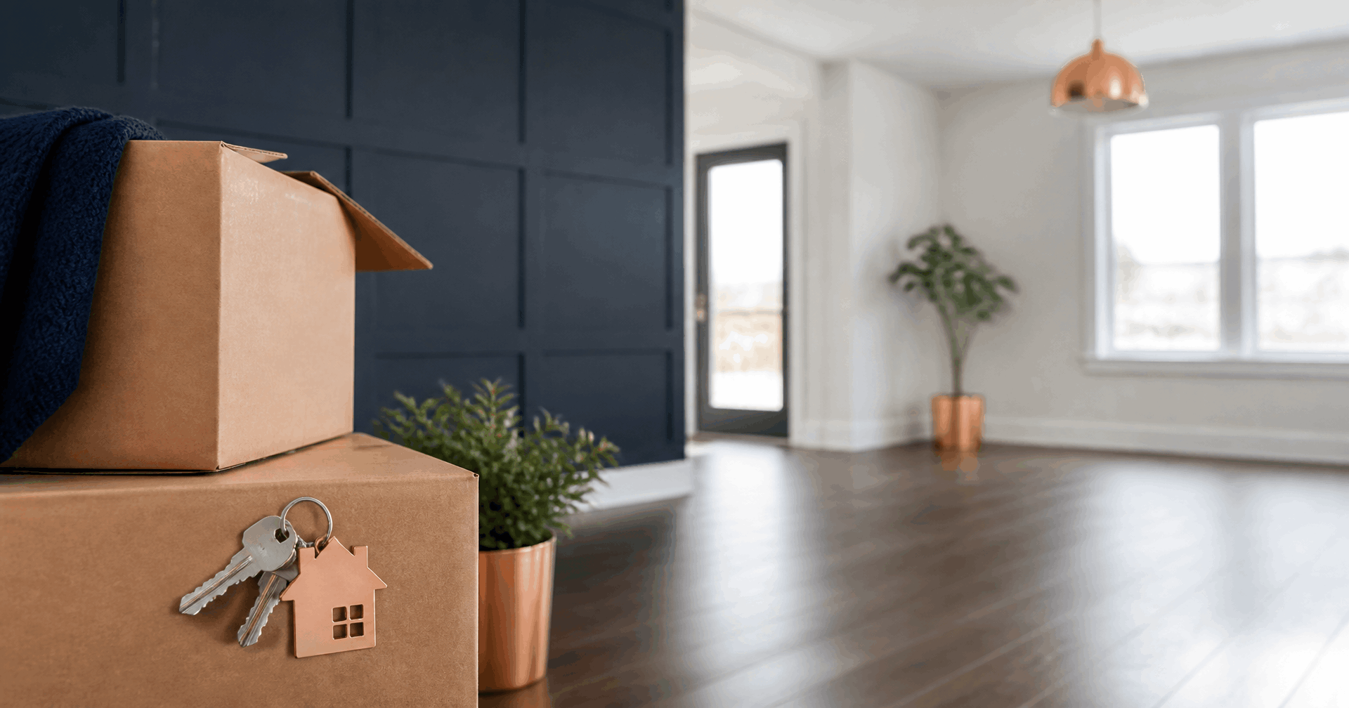 Moving boxes and house keys in a living room