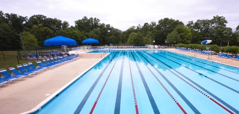 Lake Newport 50-meter pool with lane lines and blue umbrellas