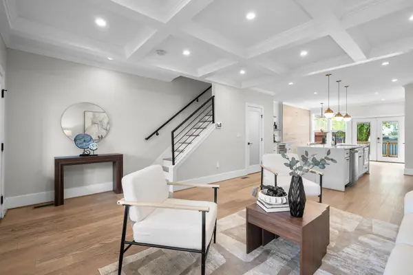 Living room with coffered ceiling and stair
