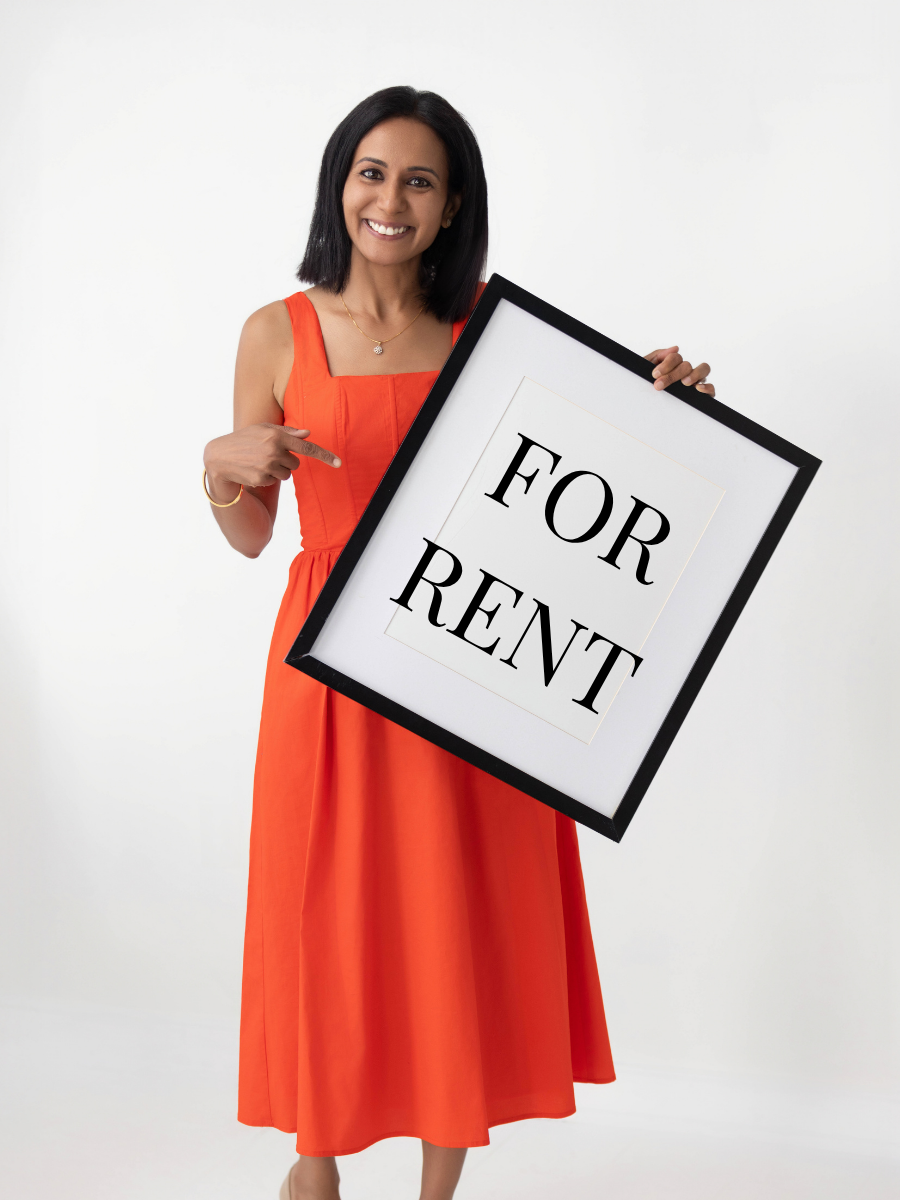 Ritu Desai holding a For Rent sign