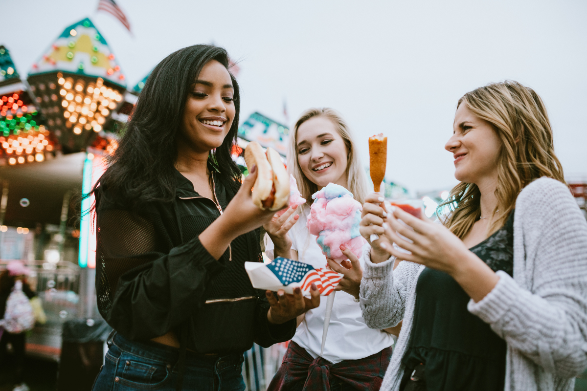 friends enjoying snacks at a fair