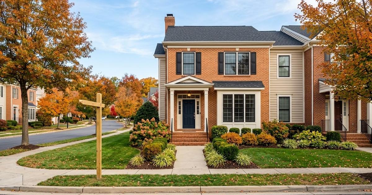 Illustration of a brick-front townhome in a Northern Virginia planned community in autumn with a blank yard sign post, for a guide comparing a Realtor and FSBO in Ashburn
