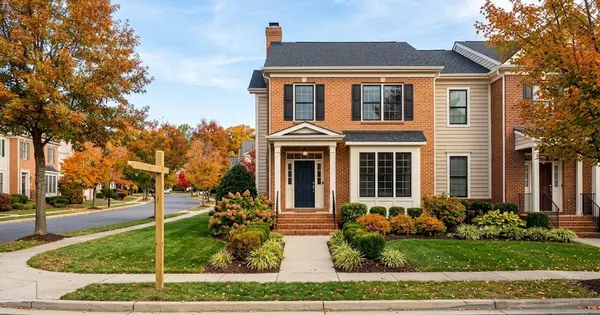 Illustration of a brick-front townhome in a Northern Virginia planned community in autumn with a blank yard sign post, for a guide comparing a Realtor and FSBO in Ashburn