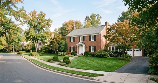 Illustration of a brick-front two-story colonial home with a green lawn and early autumn trees on a quiet Northern Virginia street, for a guide to home equity options in Ashburn