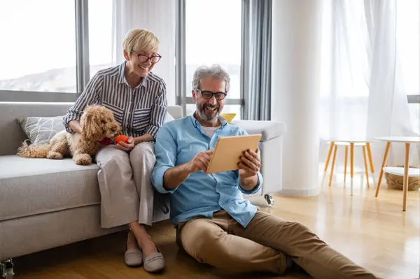 couple using digital tablet at home