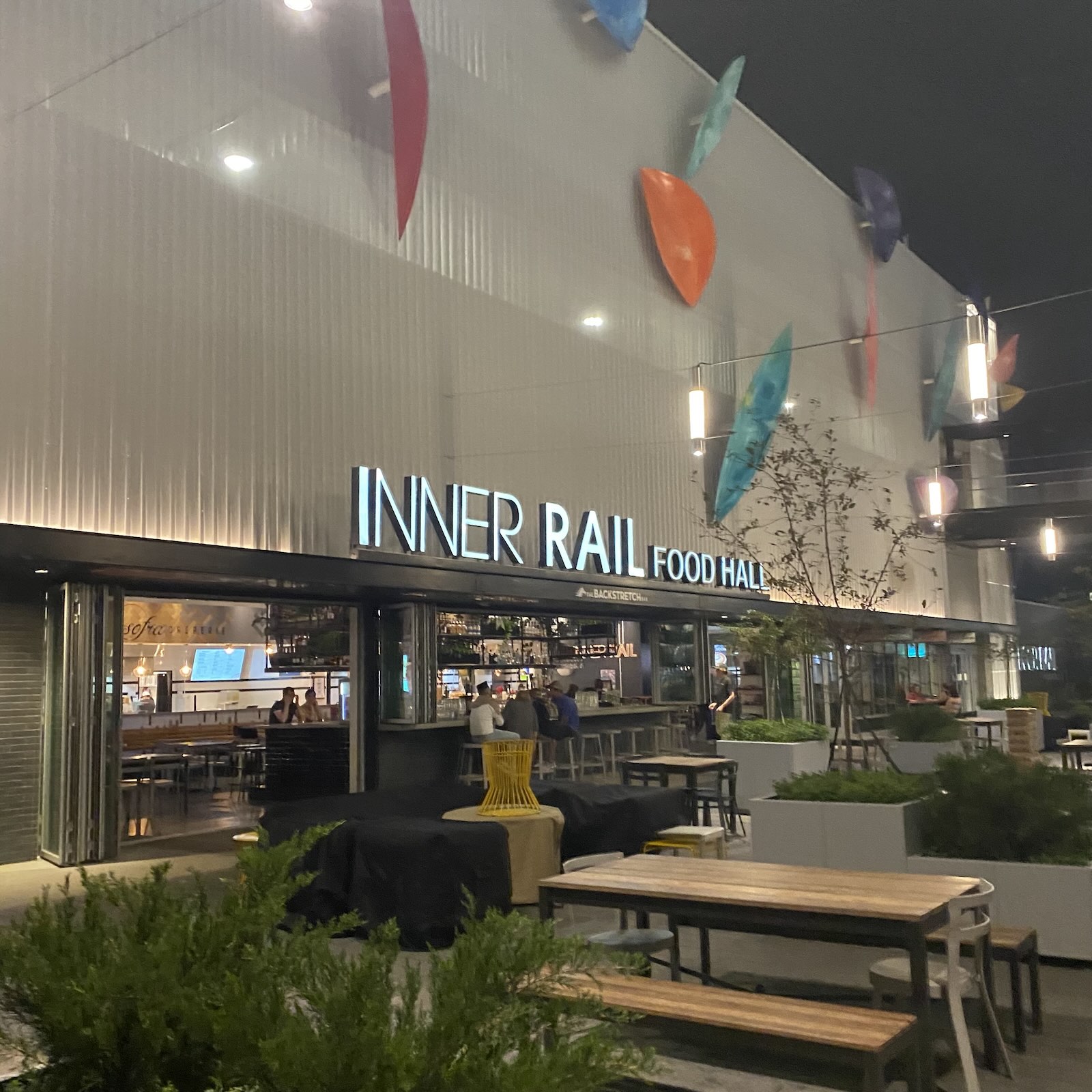 Inner Rail Food Hall lit up at night in Aksarben Village, Omaha