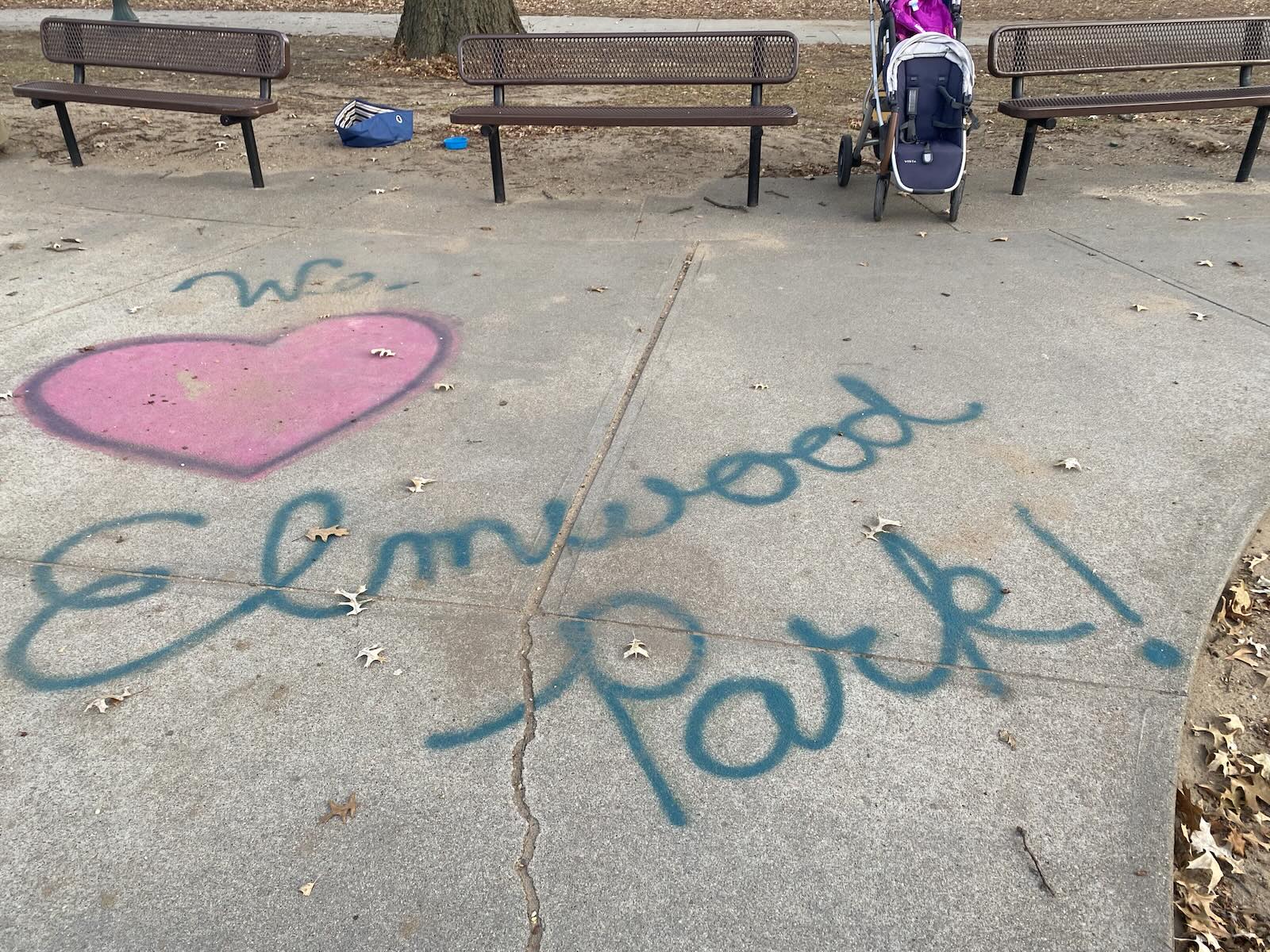 Sidewalk art reading We love Elmwood Park with benches at Elmwood Park, Omaha