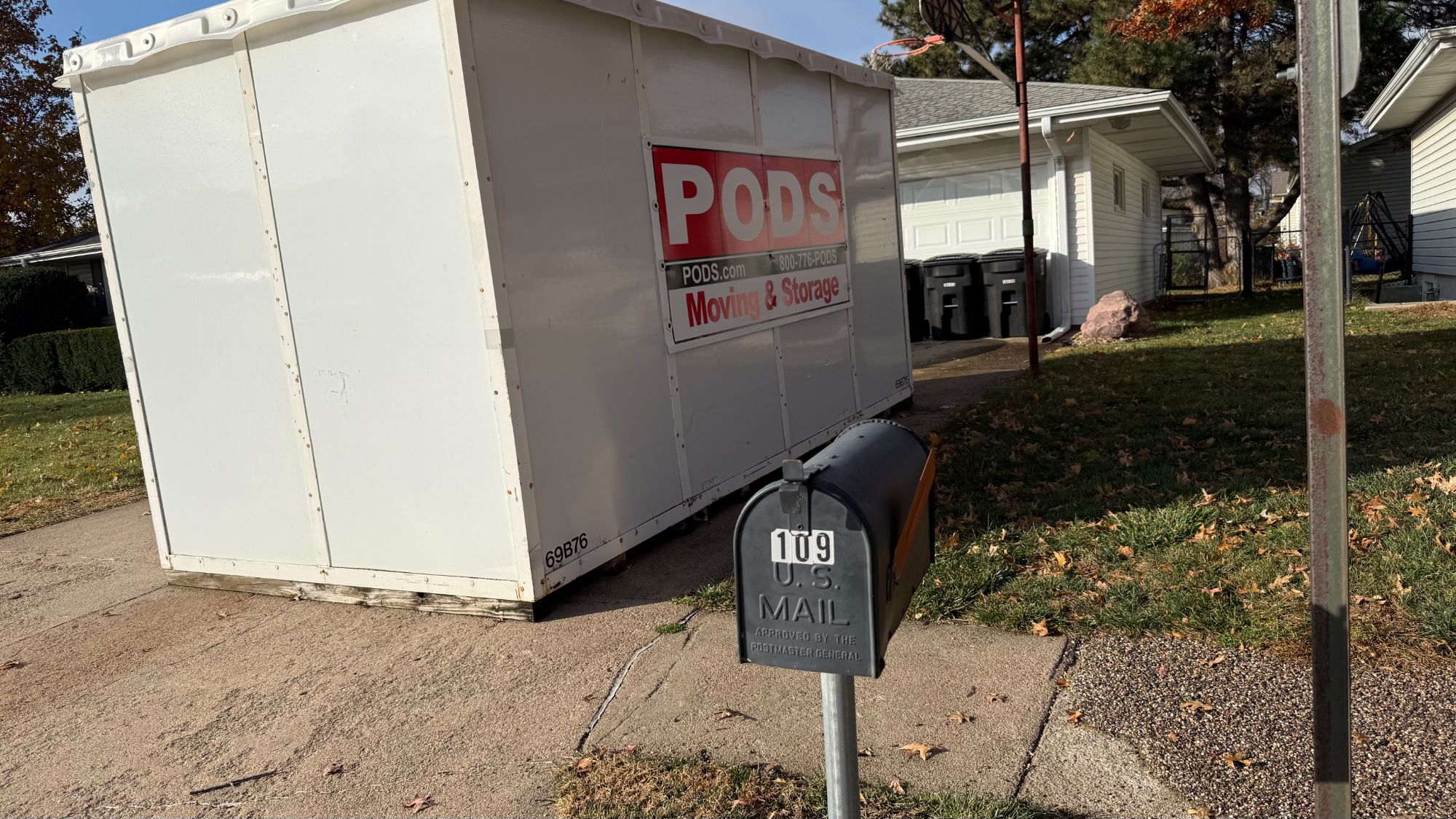 Moving pod in the driveway used to sort and store belongings while clearing out a cluttered Omaha home