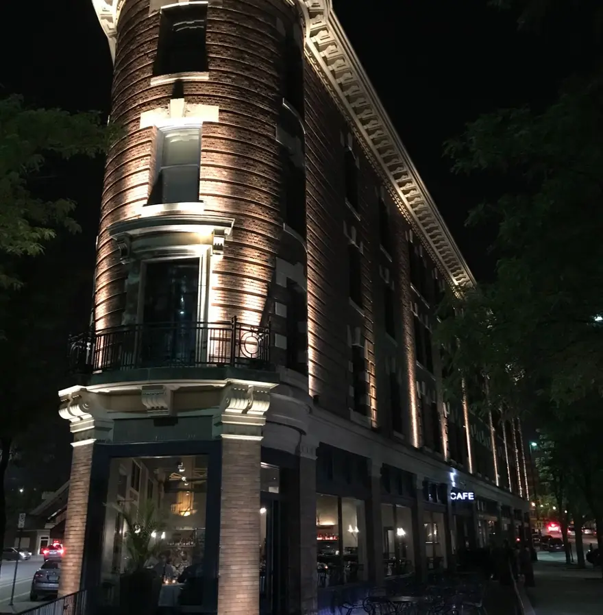 The historic Flatiron building lit up at night in downtown Omaha