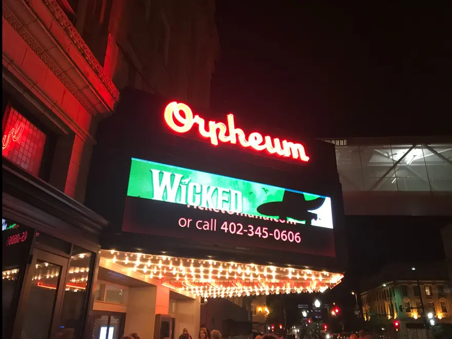 The lighted Orpheum Theater marquee at night in downtown Omaha