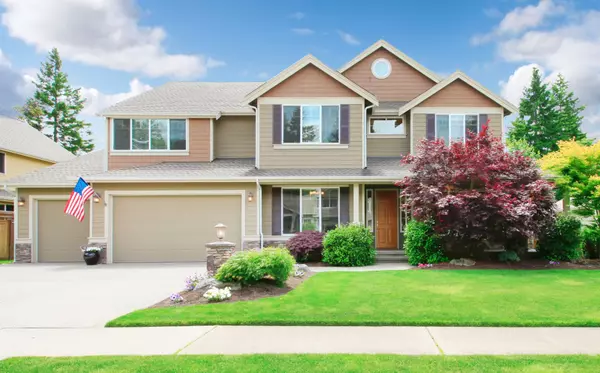 Beige large luxury house with summer landscape