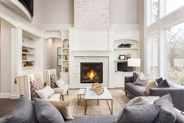 Beautiful Living Room in New Luxury Home with Fireplace and Roaring Fire