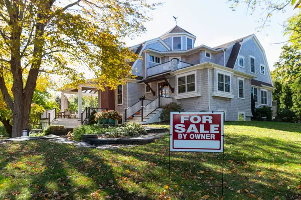 House for Sale sign in front of house