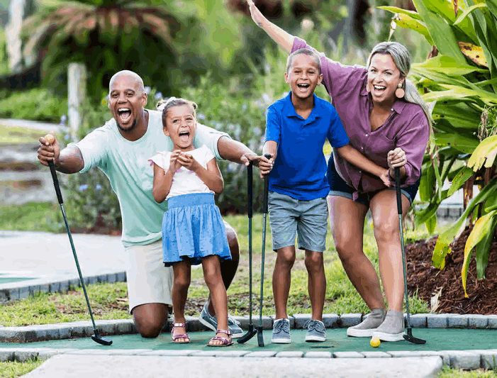 Family playing mini-golf outdoors