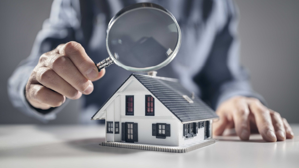 Magnifying glass over house model