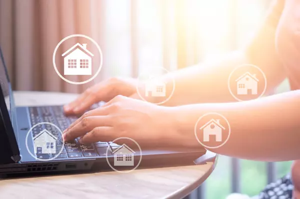 Buying, selling and renting houses or real estate concept, property online, hands typing on computer laptop as background