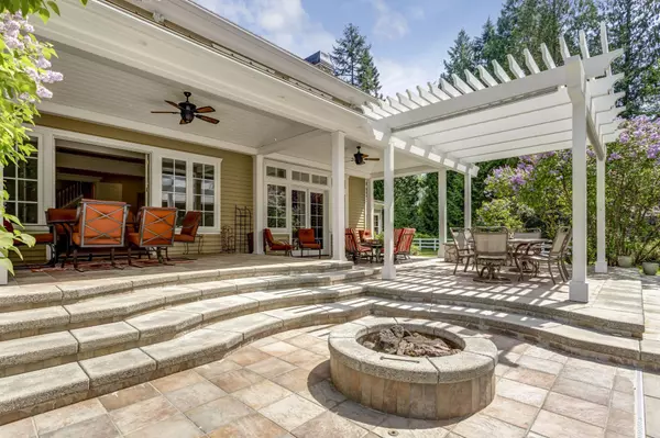 Lovely outdoor deck patio space with white dining pergola