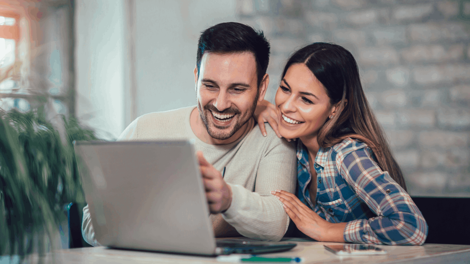 Couple carrying moving boxes into their new Southern California home