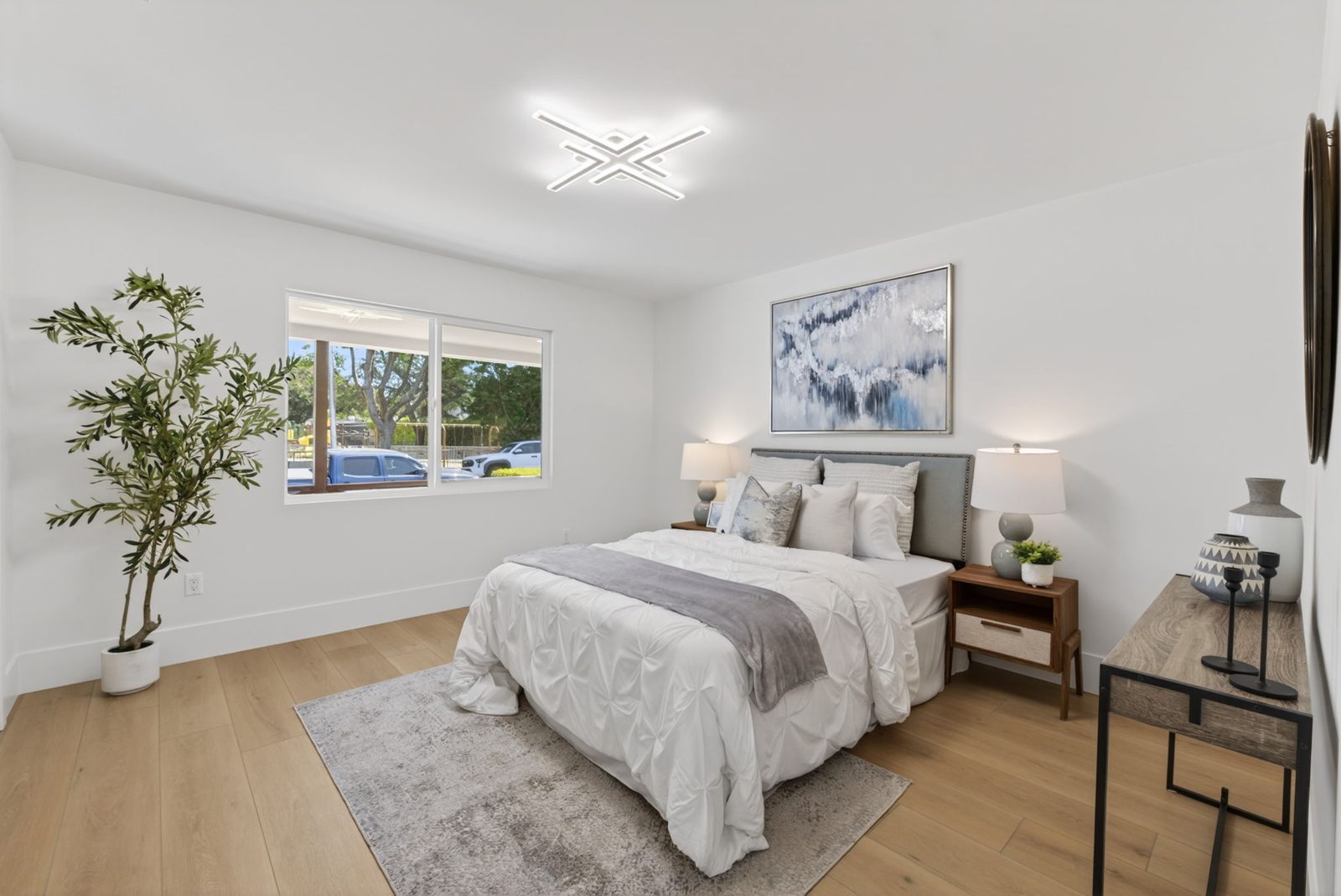 One of three bedrooms, all refreshed with new flooring, lighting and paint.