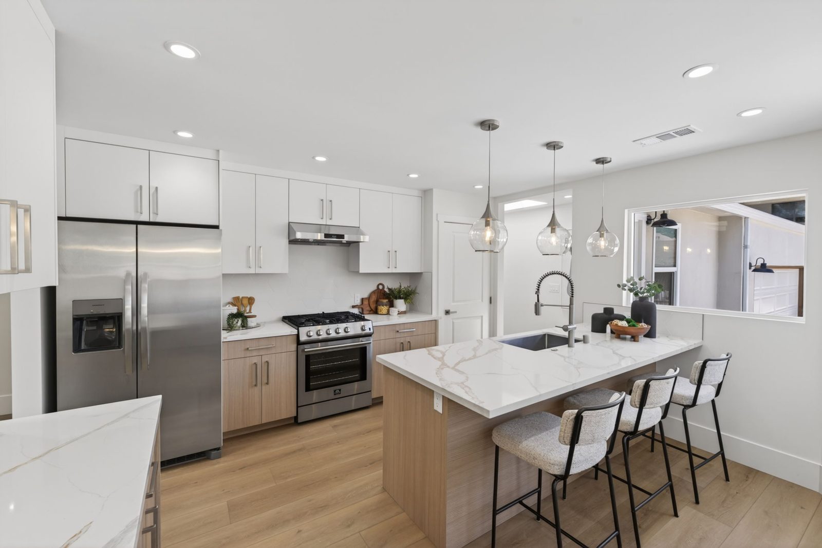 The fully remodeled kitchen: new cabinetry and counters, stainless appliances and a gas range.