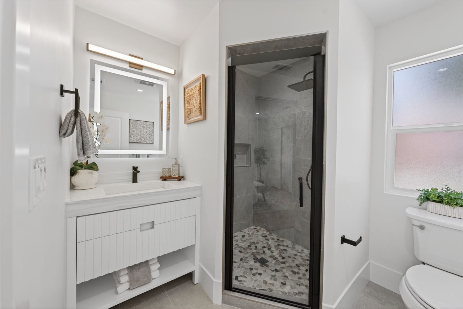 The existing second bath, remodeled with city approval, now with a glass walk in shower.