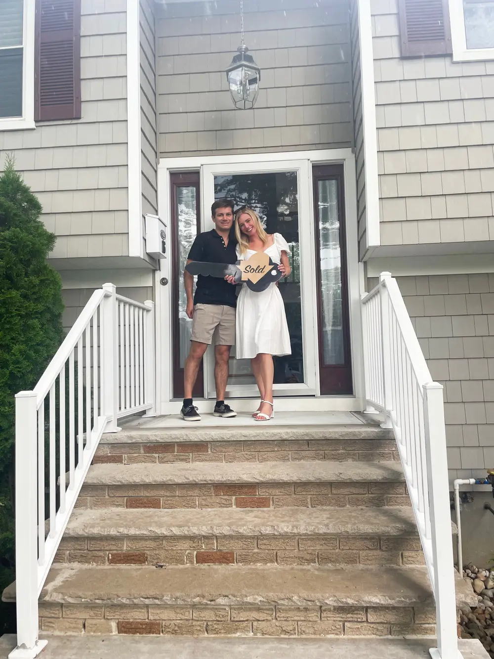 ProLegacy Realty buyers on the front steps of the home they just bought