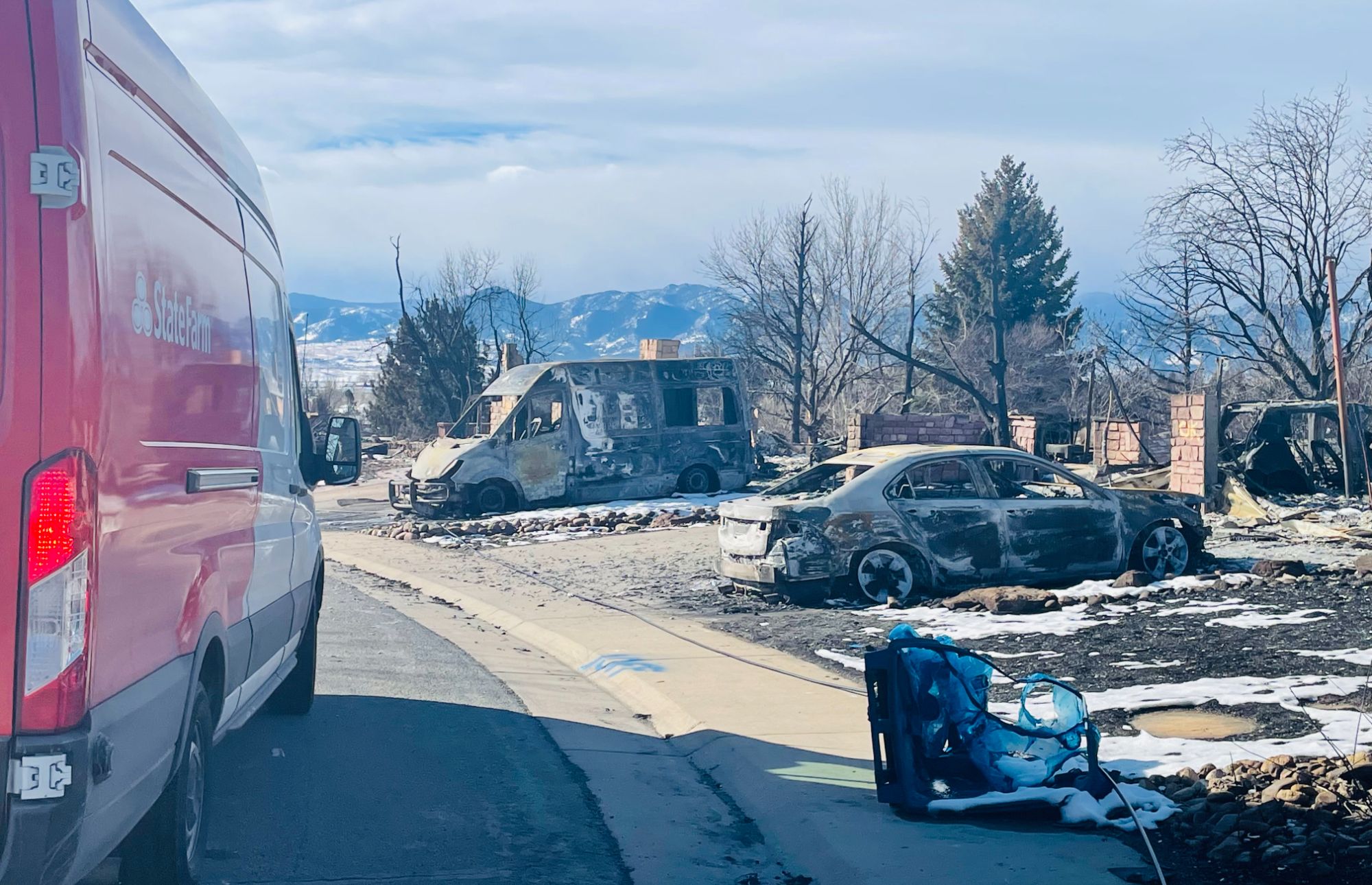 Insurance response personnel in a Louisville Colorado neighborhood after the Marshall Fire