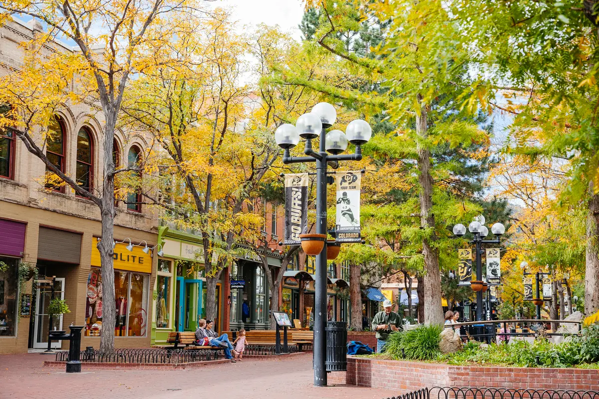 Pearl Street Mall in Boulder, Colorado during fall, showcasing walkable downtown living and Boulder real estate lifestyle.