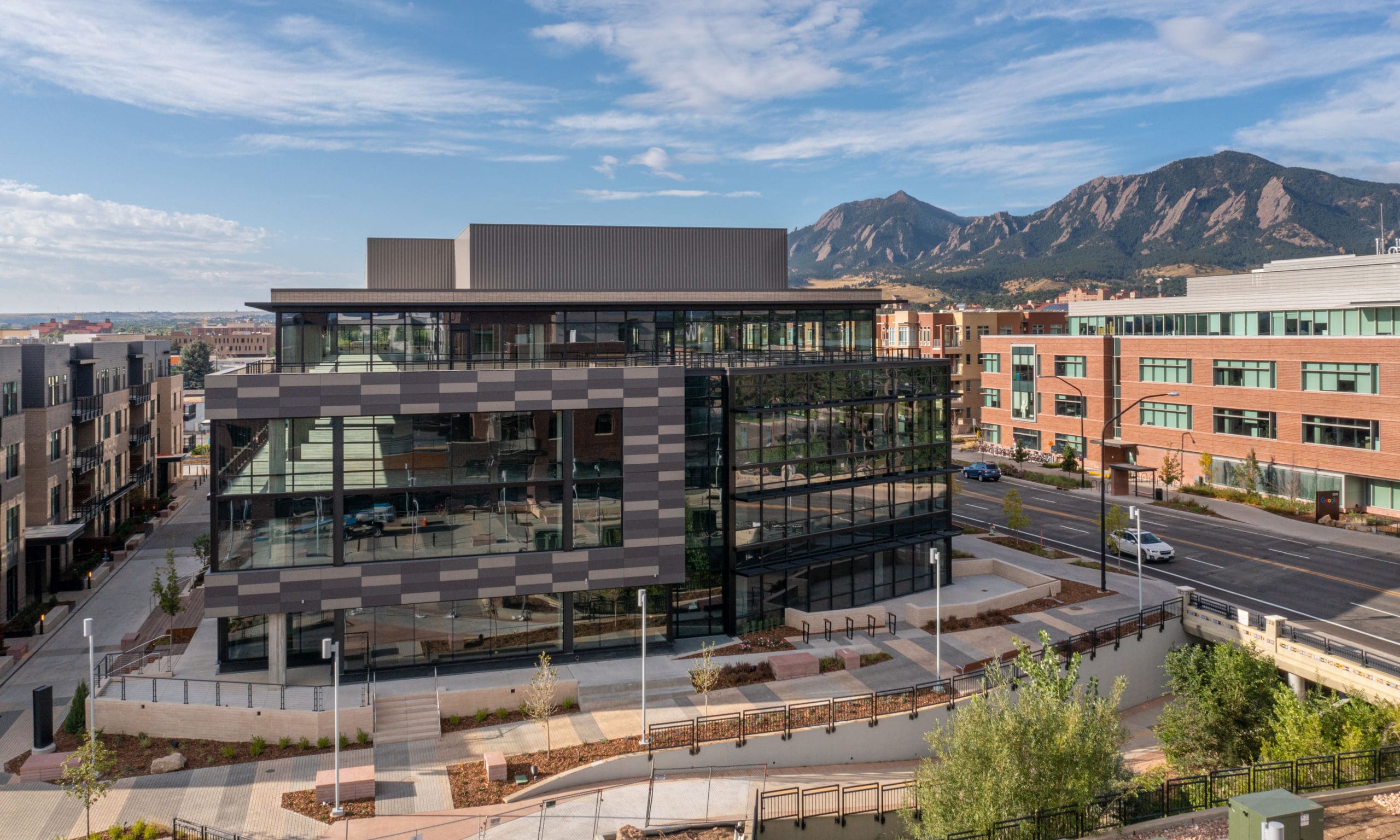 Modern downtown Boulder, Colorado architecture with Flatirons mountain views, showcasing urban living and Boulder real estate.