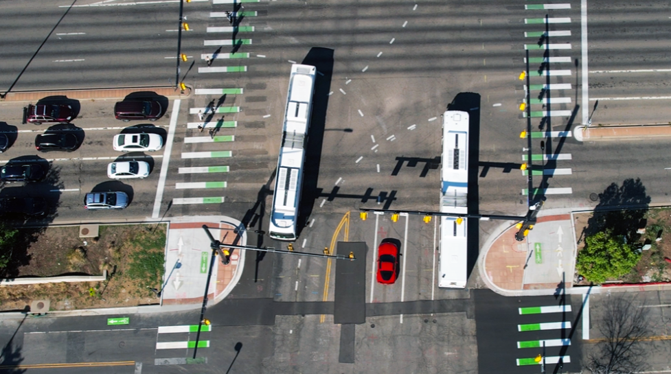 Aerial view of Boulder, Colorado streets with bus transit and bike lanes, highlighting walkable neighborhoods and Boulder urban living.