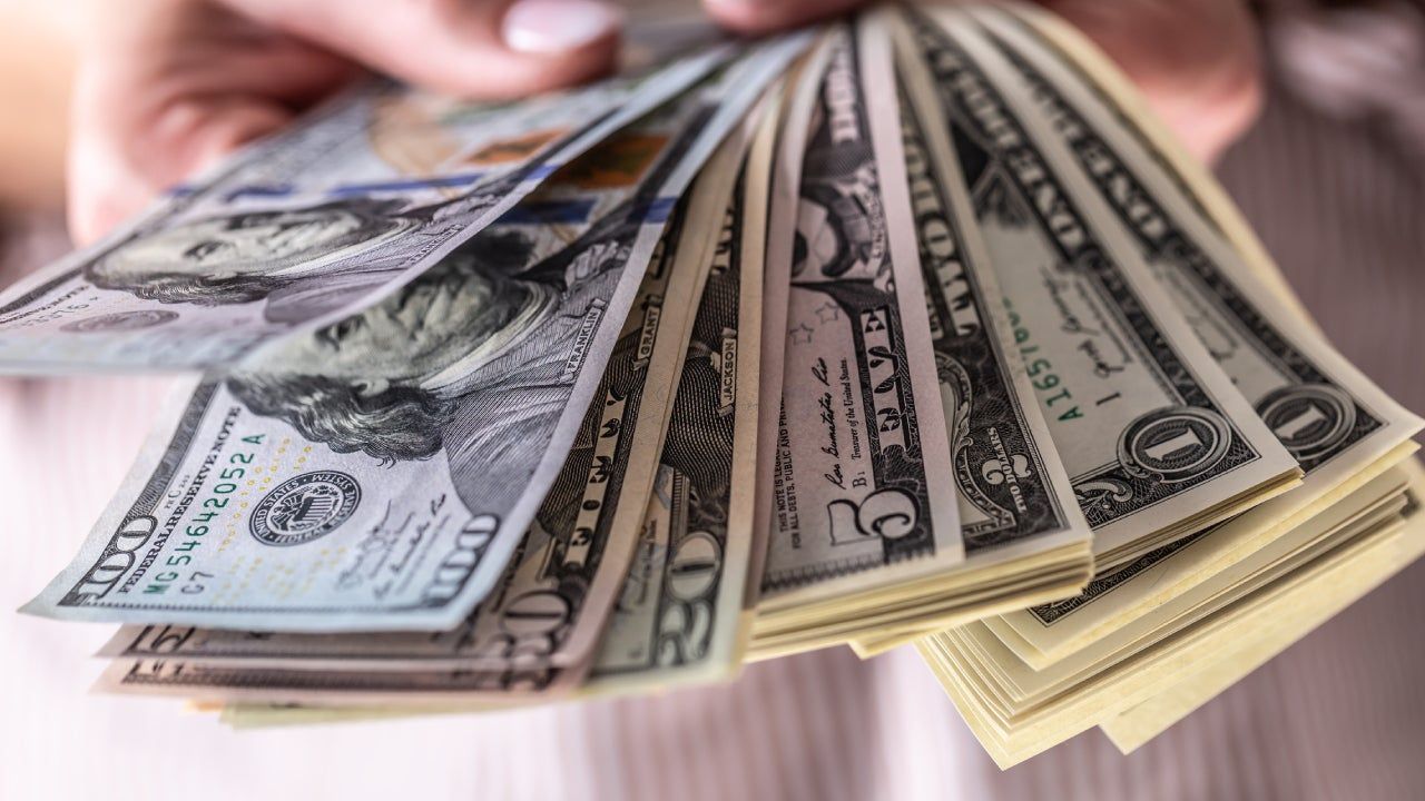 Cash and U.S. currency representing home buying costs, financing, and real estate transactions in Boulder, Colorado.