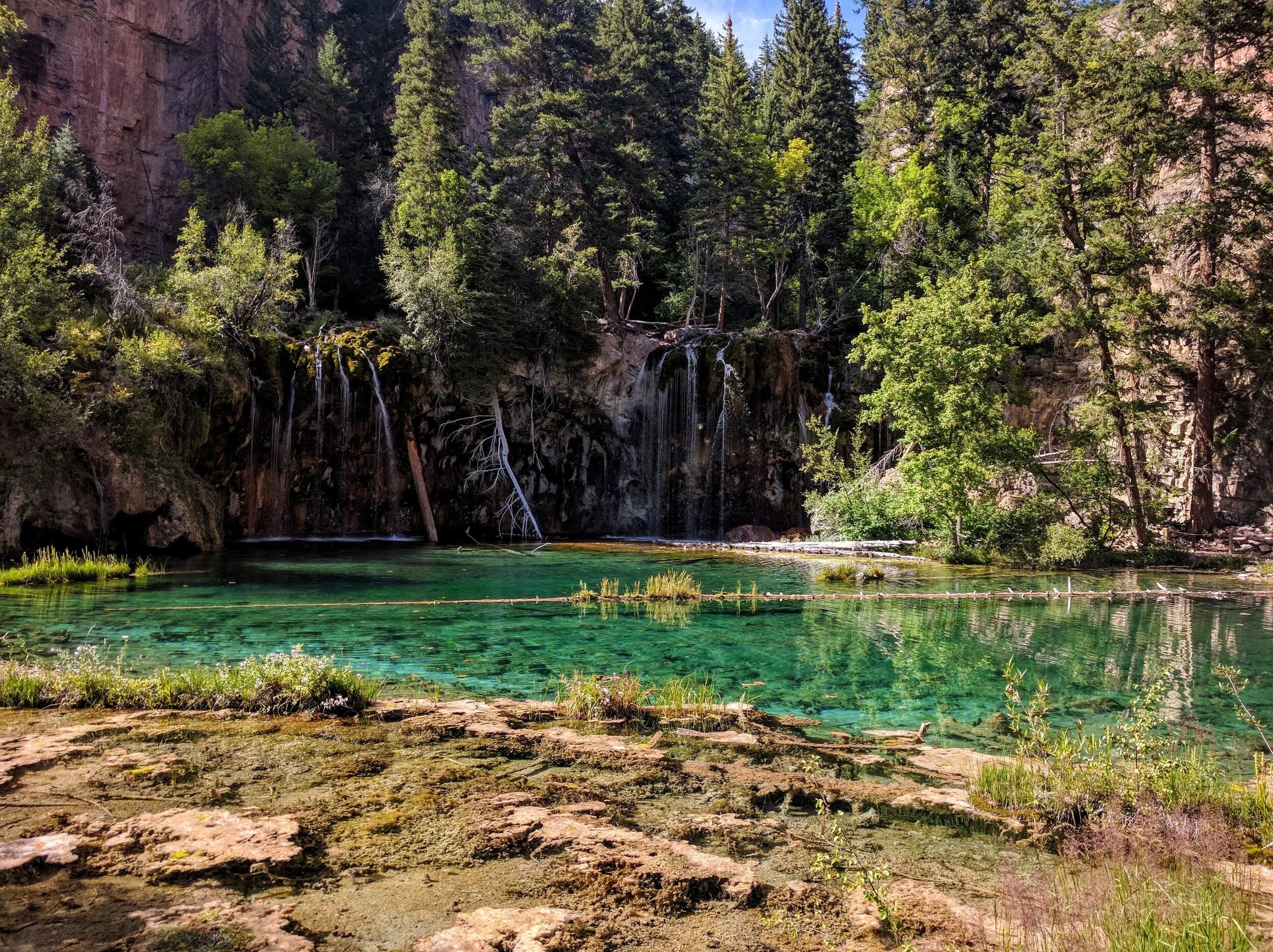Hanging Lake in Colorado with waterfalls and emerald water on a day trip from Boulder.