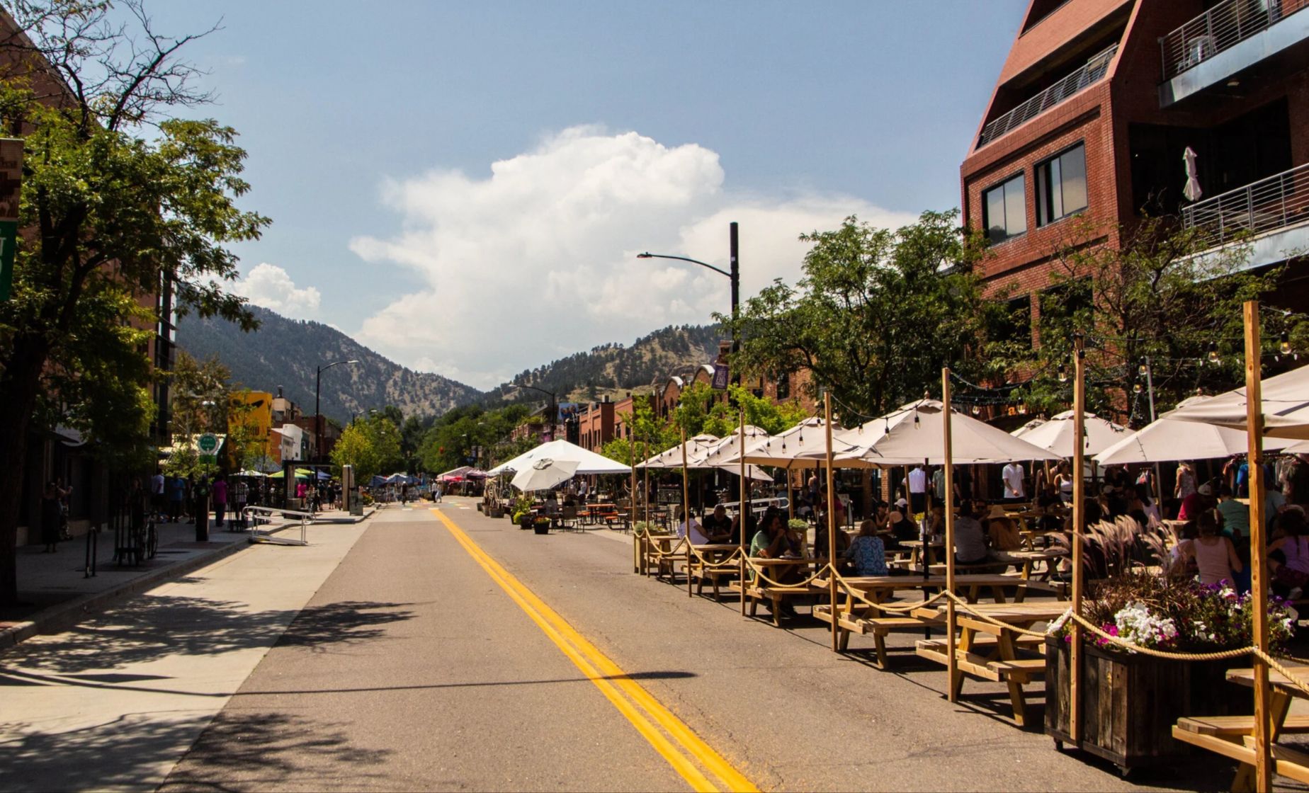 Restaurant patio tables along Pearl Street in downtown Boulder on a summer afternoon