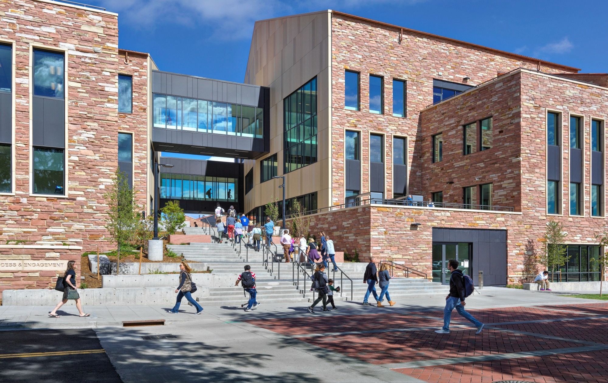 Prospective students and parents walking on a CU Boulder campus tour.