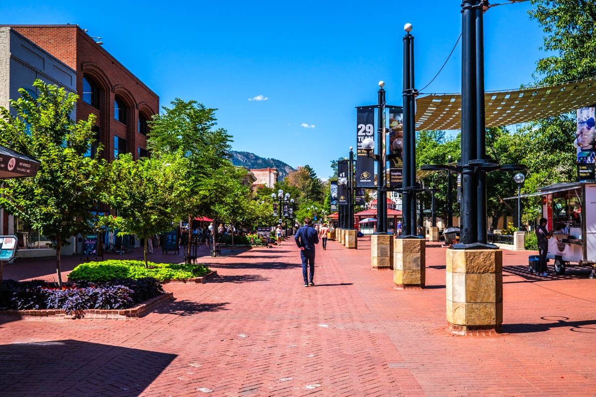 Person walking from a Boulder residential street toward nearby cafés and restaurants while evaluating neighborhood access.