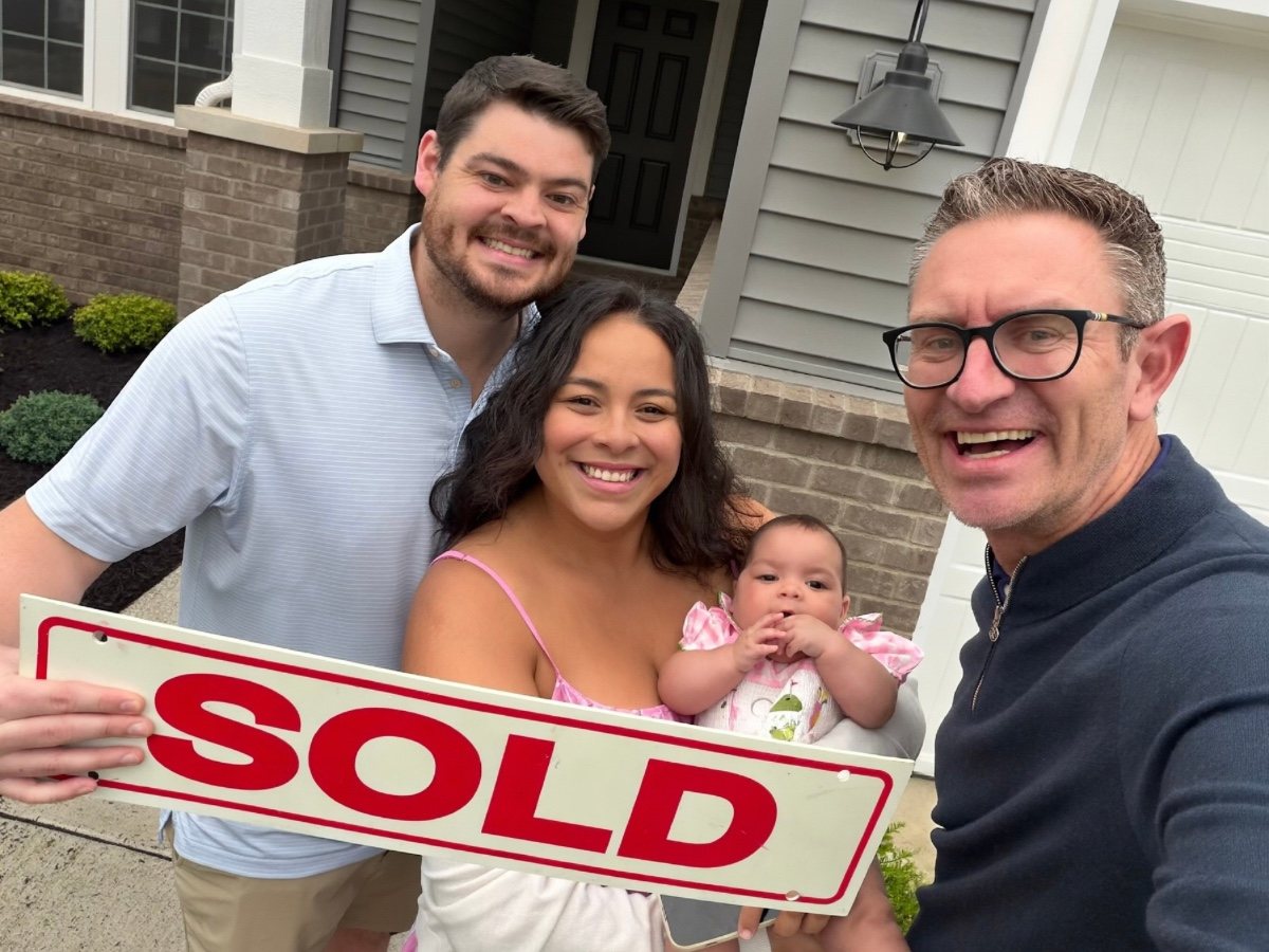 Jeff Duneske celebrating a home closing with John & Claudia in New Hudson, Michigan