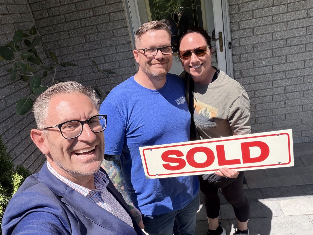 Jeff Duneske celebrating a home closing with Gina & James in Wixom, Michigan