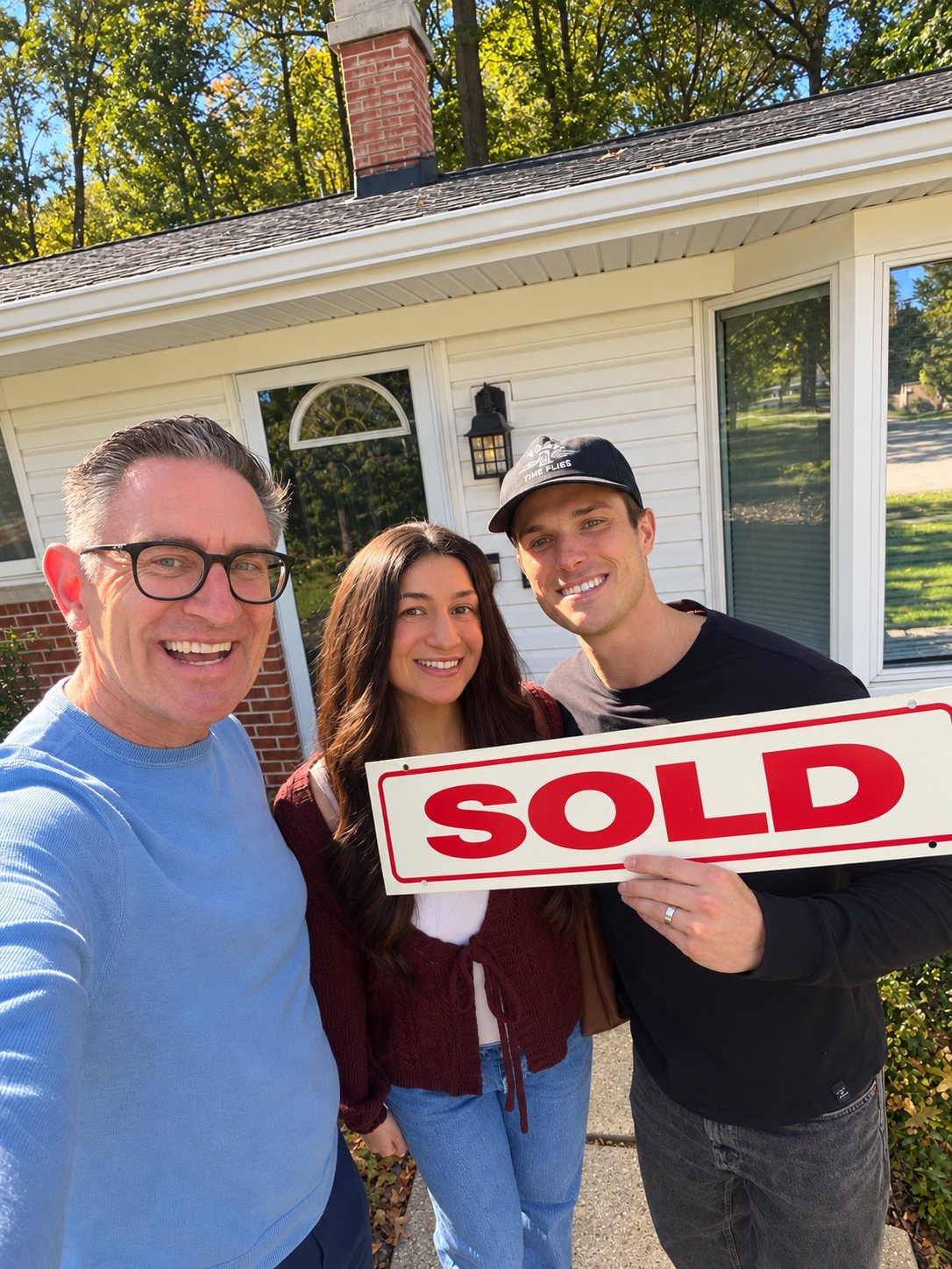 Jeff Duneske celebrating a home closing with Matt & Brianna in Livonia, Michigan