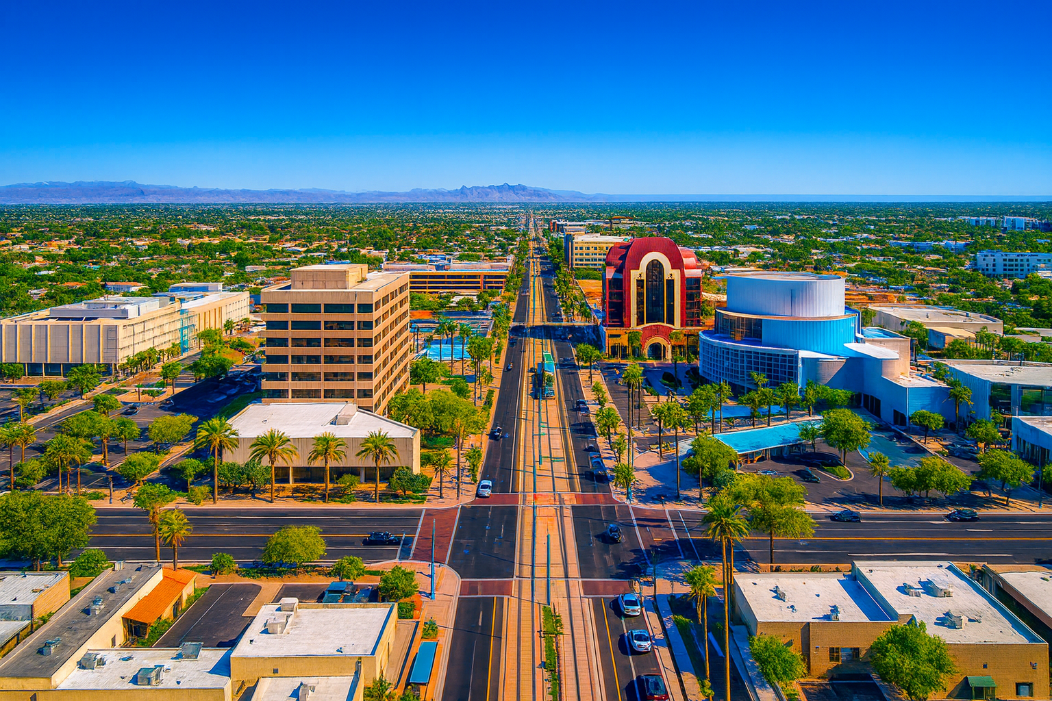 Downtown Mesa skyline view at sunset with palm trees