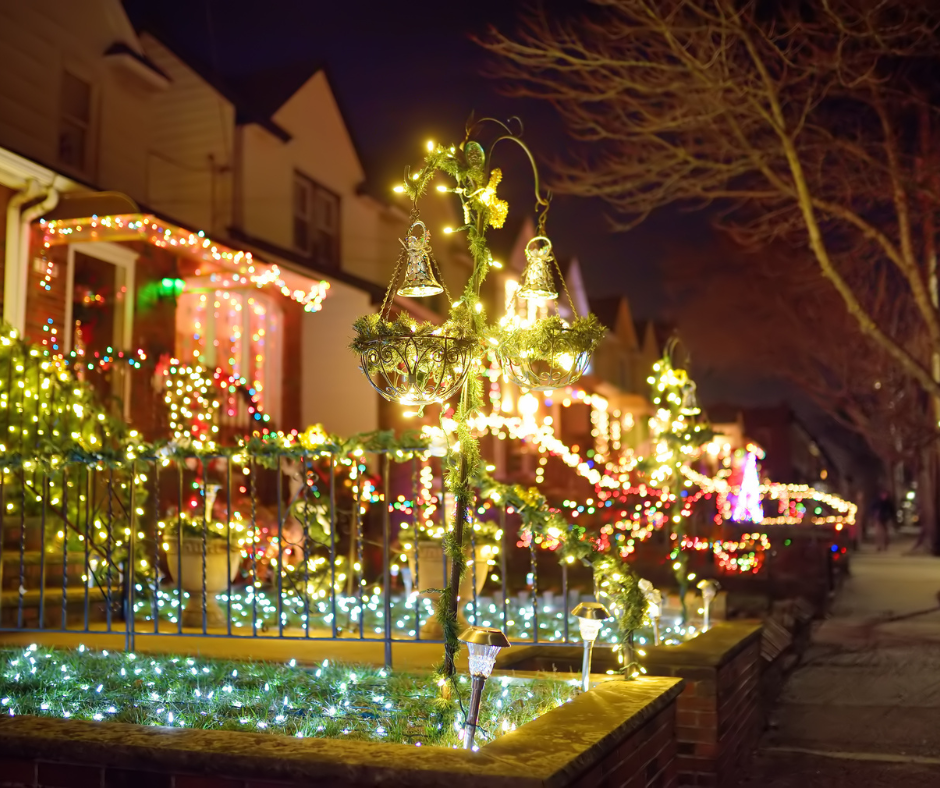 East Valley neighborhood with glowing holiday lights and families walking at night